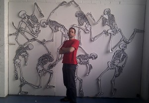 Me in front of a large group of skeleton drawings.