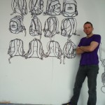 Me standing in front of rucksack drawings.