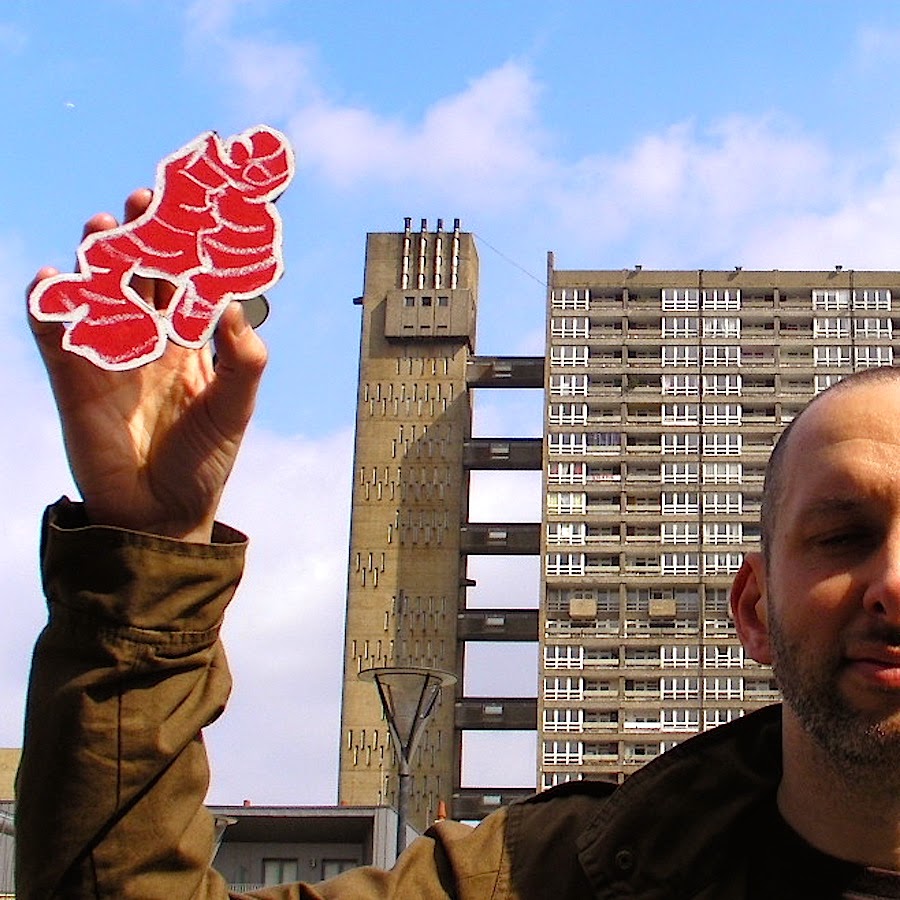 Holding a drawing of Root Ginger, outside Balfron tower, Poplar.